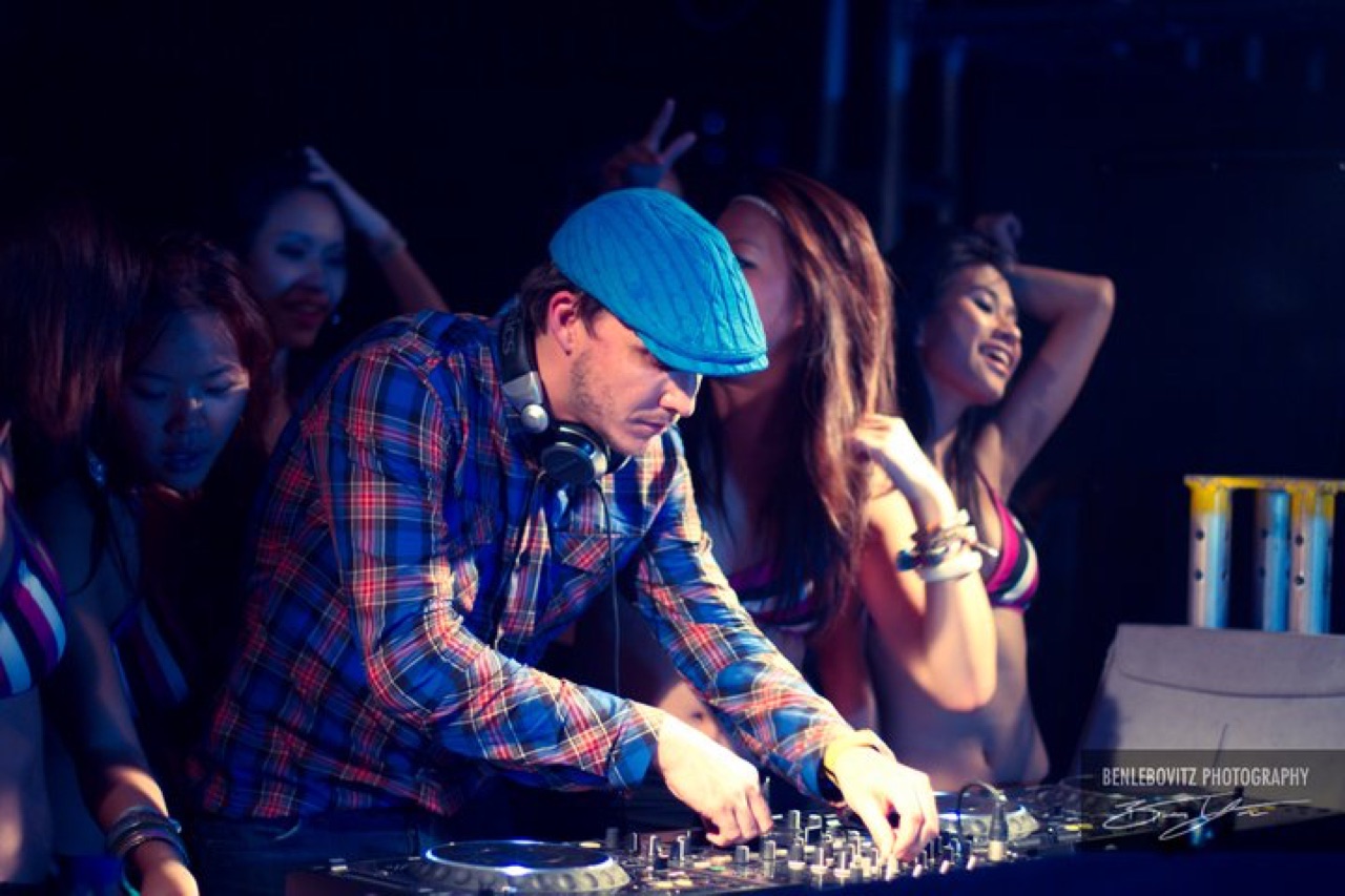 DJ Ryan Ash performing at peak-hour CDJs, crowd dancing